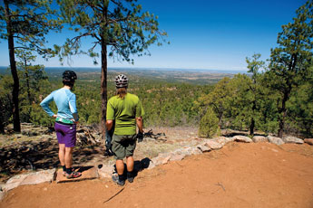 International Mountain Bike Association trail consultant Jill Van Winkle and Gallup Trails 2010 president Bill Siebersma survey the Lost Lake Rim overlook on Monday.  © 2011 Gallup Independent / Brian Leddy 